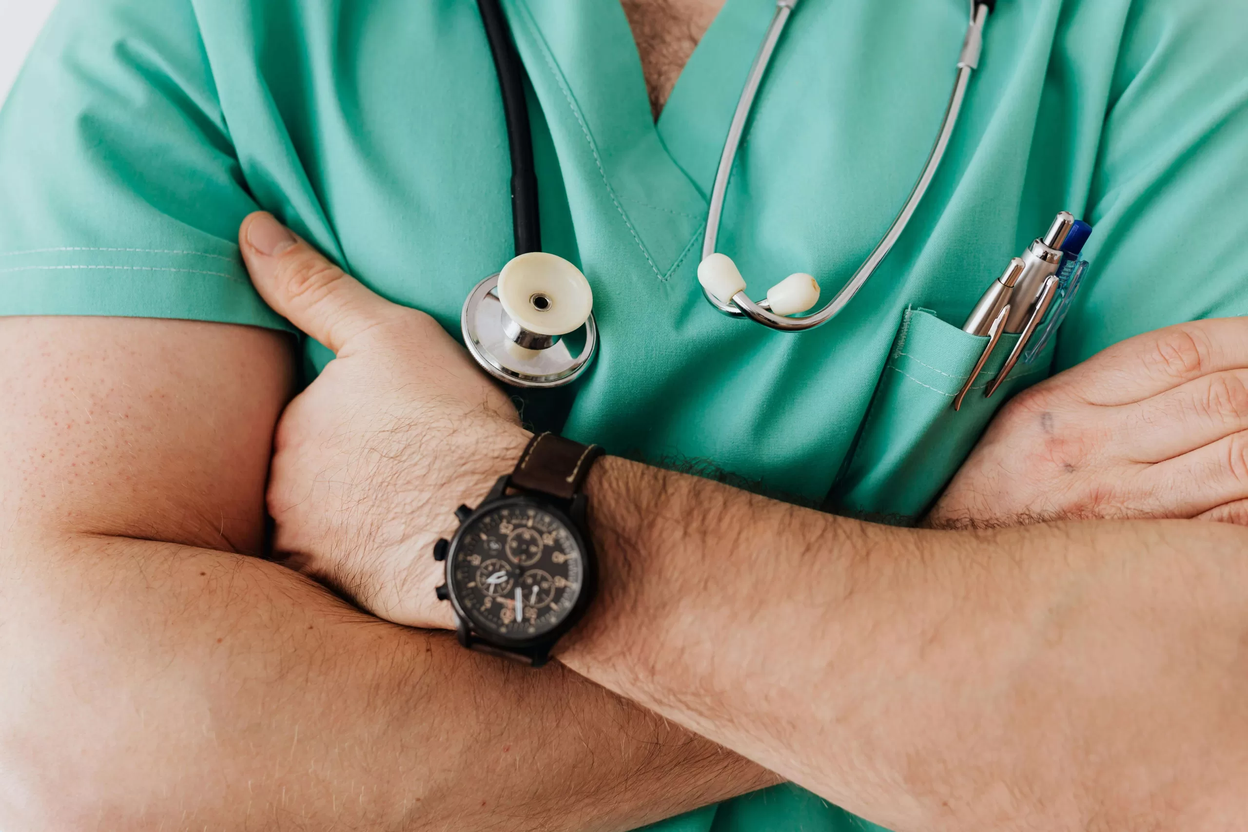 A healthcare professional handling medical instruments in a clinical setting.